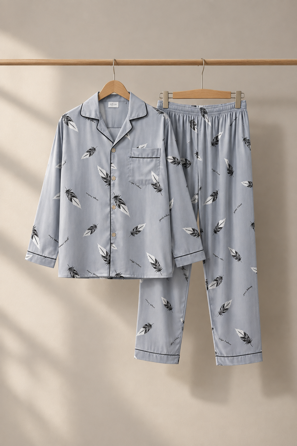 Gray feather print pajama set on hangers