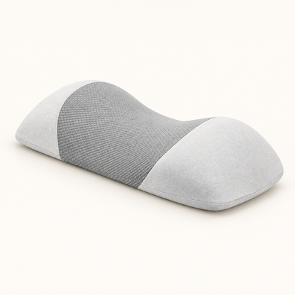 Light gray contoured memory foam waist pillow on a warm white background
