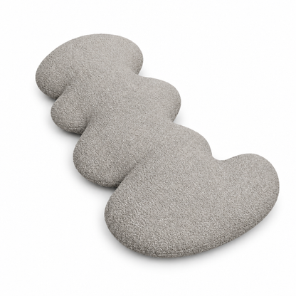 Gray wave accent pillow with curved silhouette on white